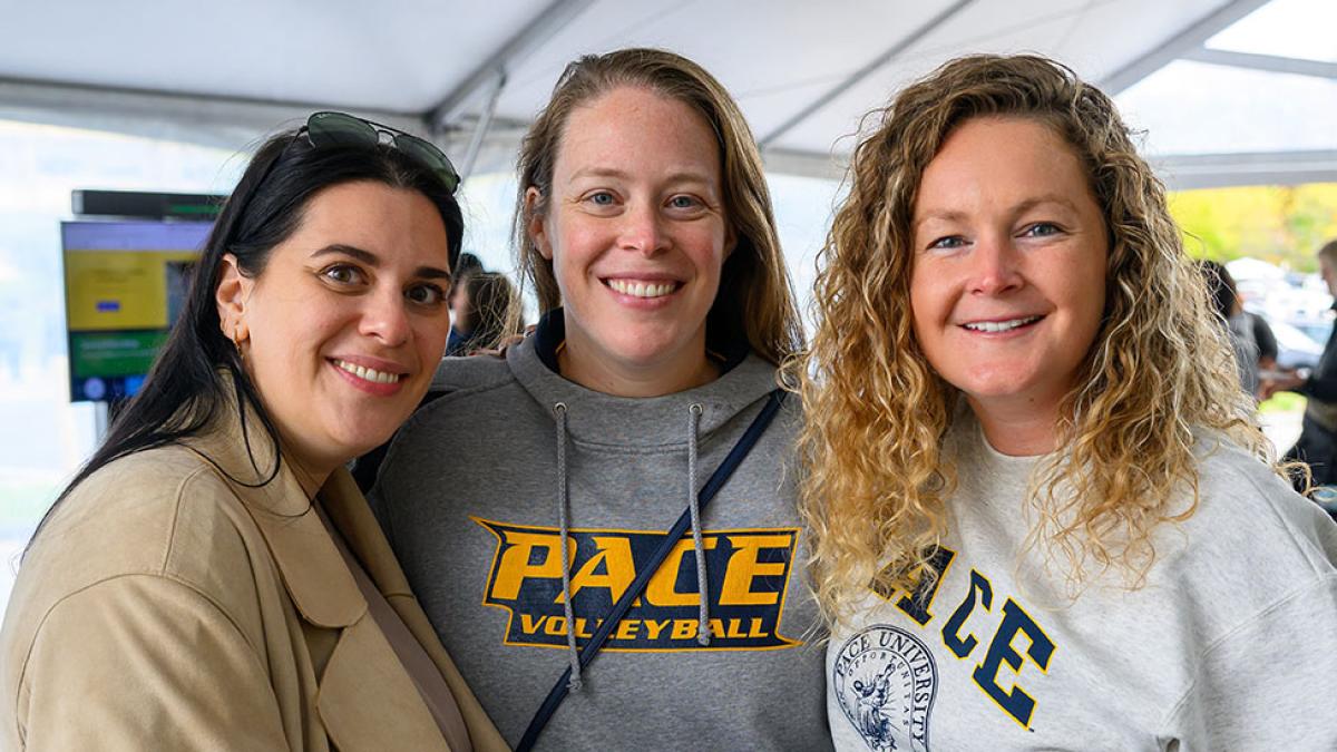 Pace University alumni smiling at the camera at the Alumni Homecoming Breakfast & Showcases.