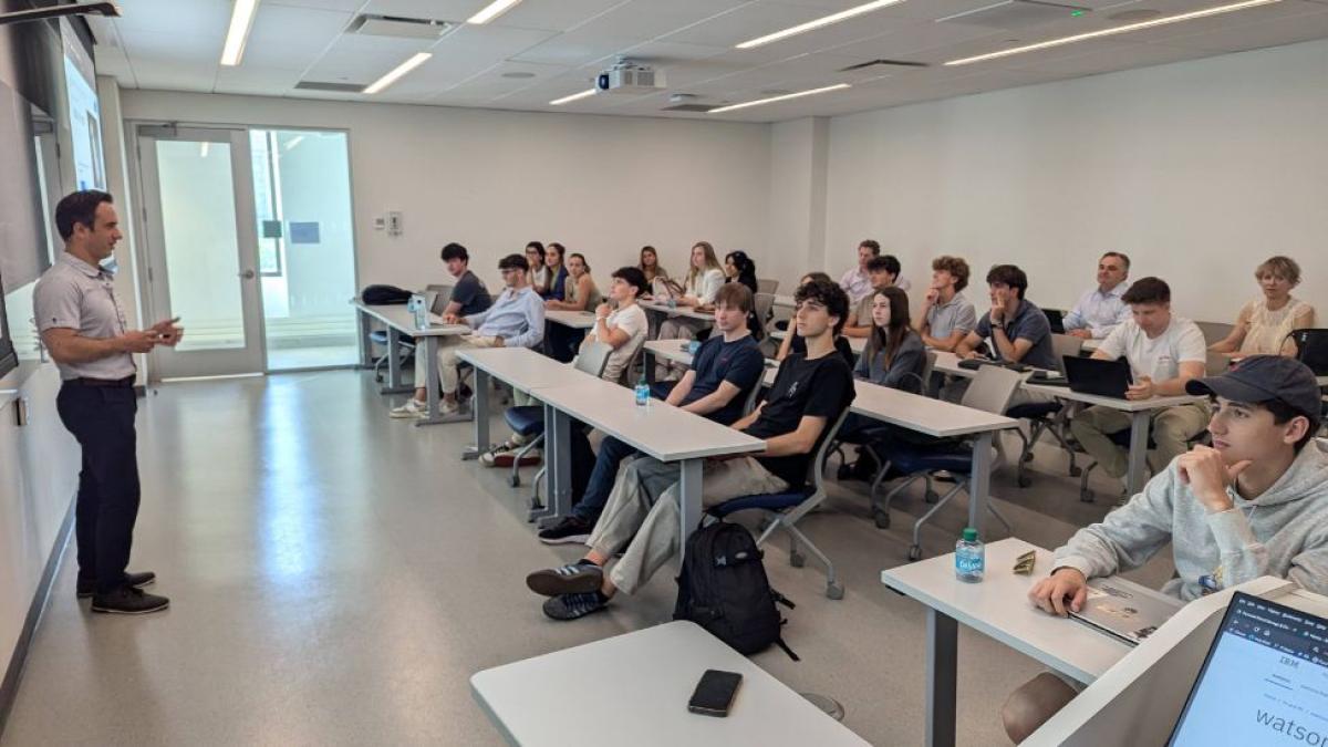 Seidenberg Professor Dr. Yegin Genc teaching in front of a full classroom of students from LaSalle Barcelona.