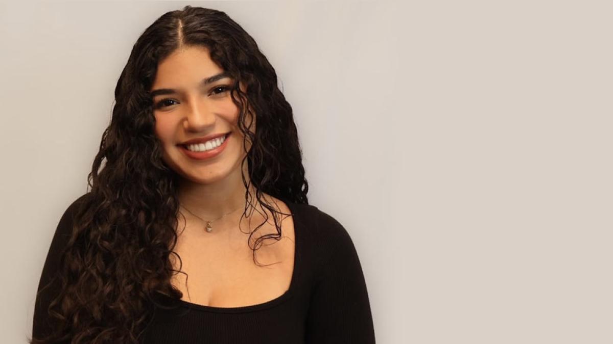 Melanie Prado smiling at the camera.