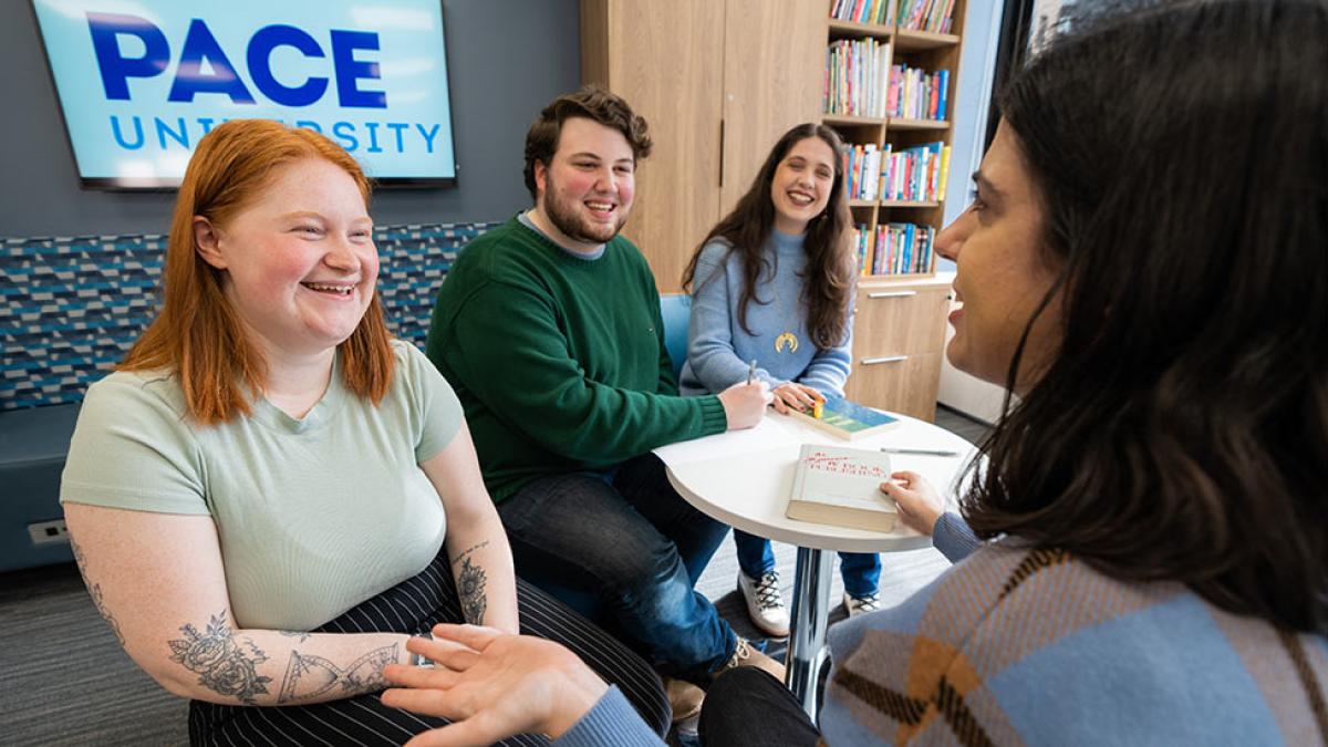 Pace University students talking in a classroom