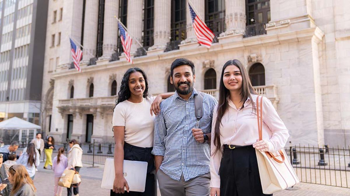 Pace University graduate students enjoying a day in NYC, smiling at the camera.