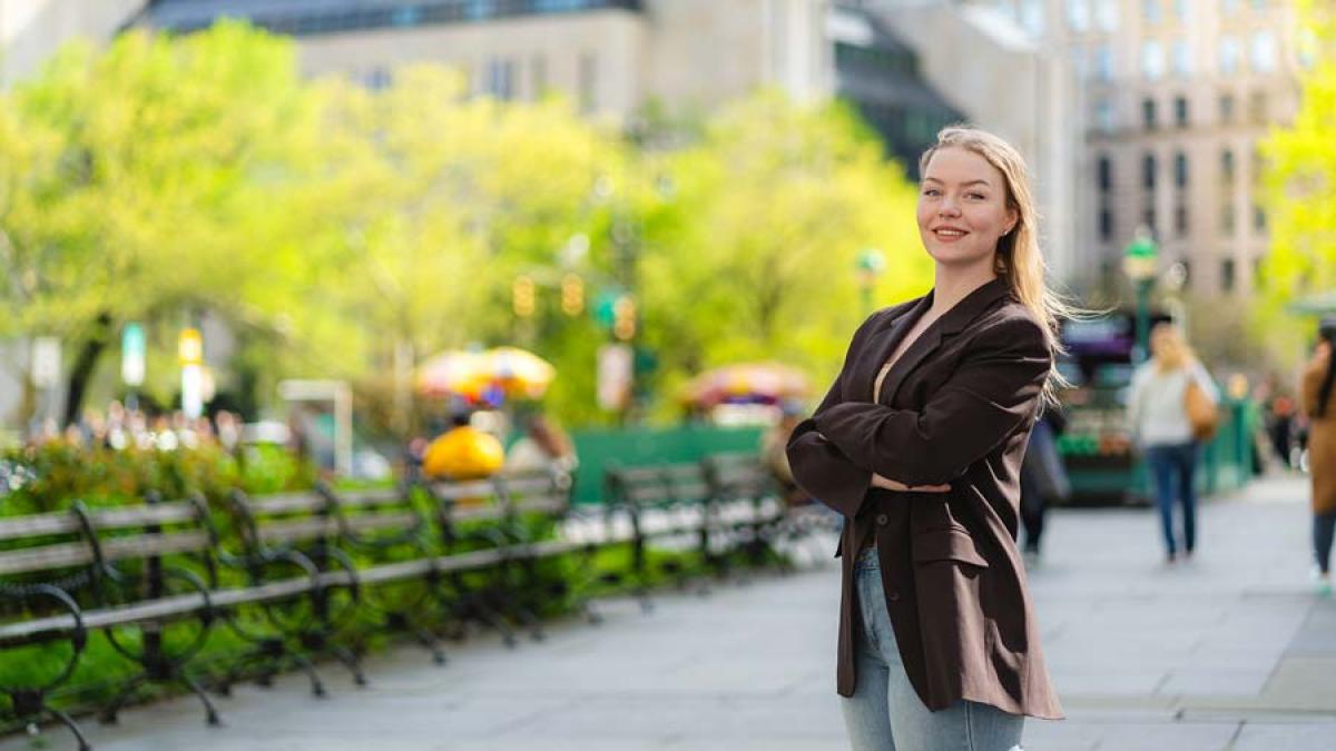 Pace student standing in City Hall Park in Lower Manhattan