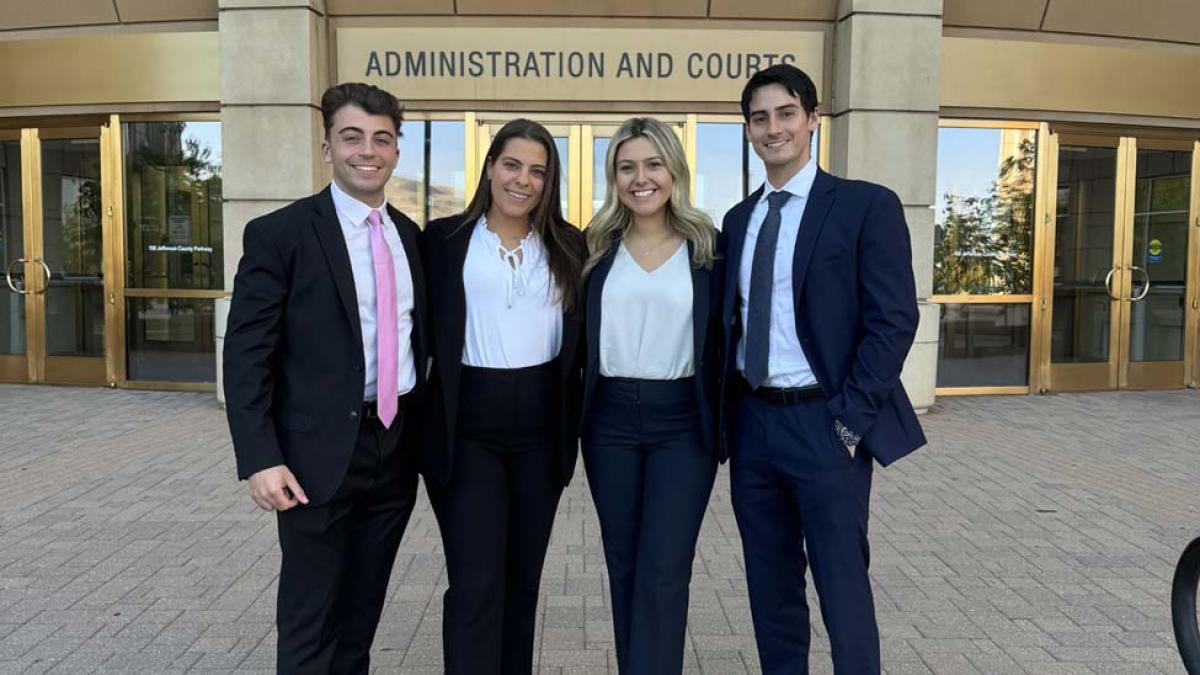 Four Elisabeth Haub School of Law students posing in front of Jefferson County Colorado Administration and Courts Building