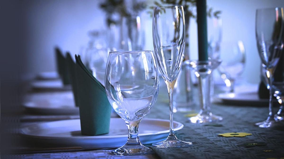 water glass, wine glass, napkin, and plate on formal table setting