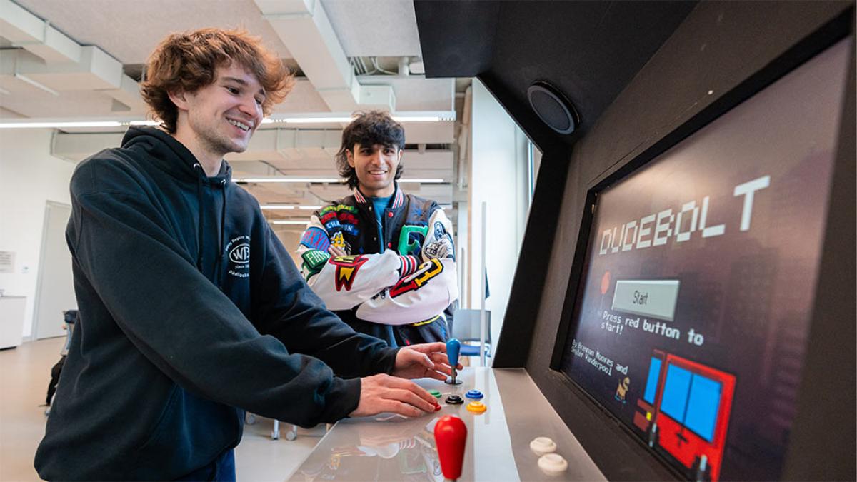 Two pace university students playing video games.