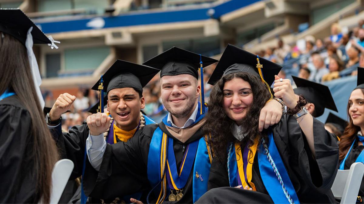 Pace University graduates posing for the camera at Commencement. 