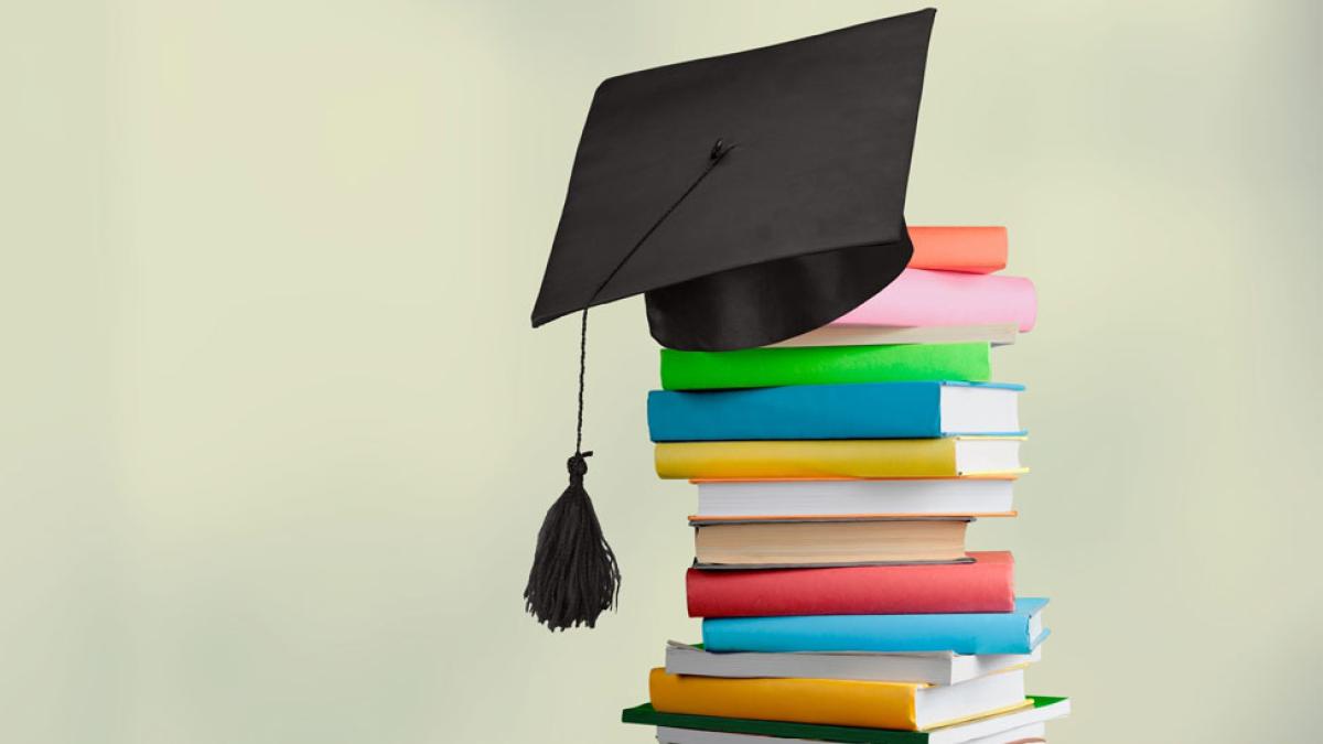 A stack of books with a mortarboard perched atop. 