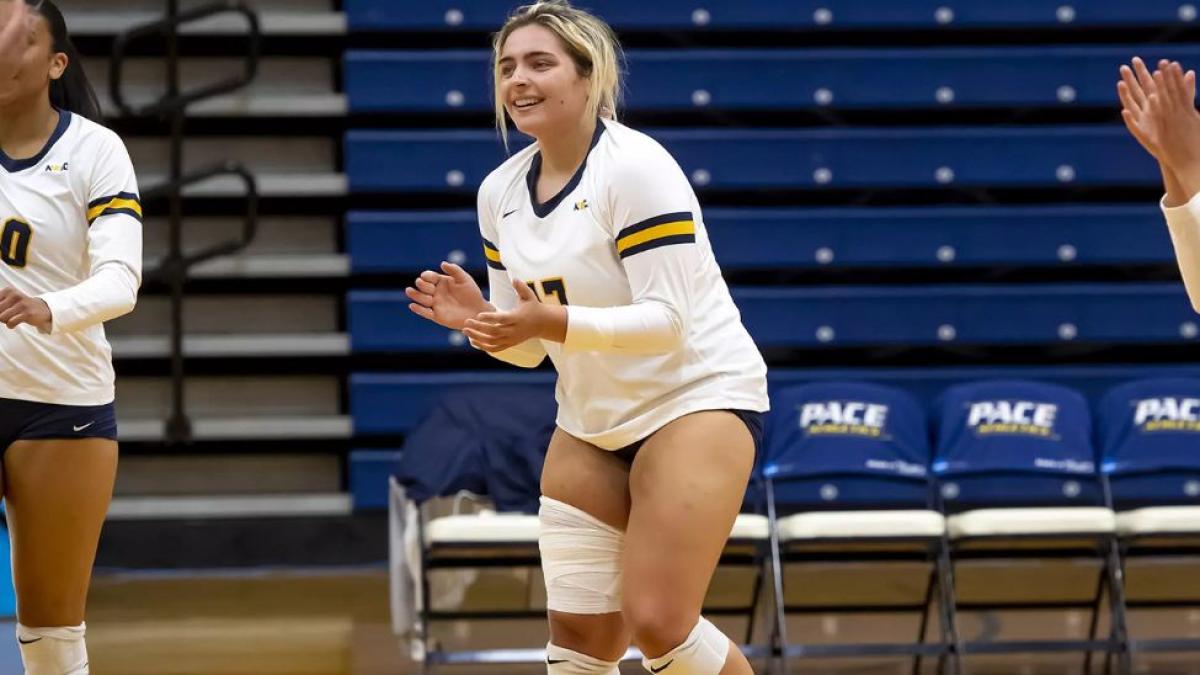 Stephanie Sicilian, student at Pace University's Seidenberg School of CSIS standing on the volleyball court during a game for Pace's women's volleyball team.