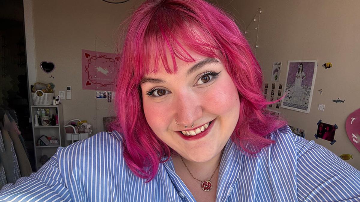 Pace University student Sunny Shenkman sports pink hair and a smile.