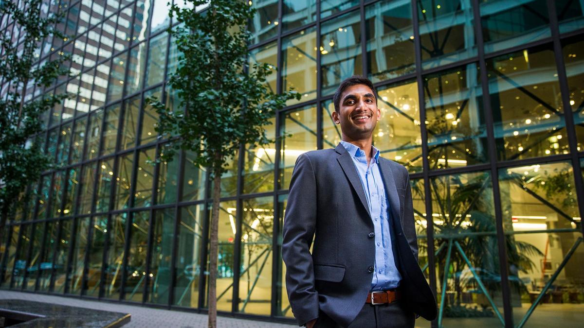 Pace University student dressed in a suit outside a building in NYC