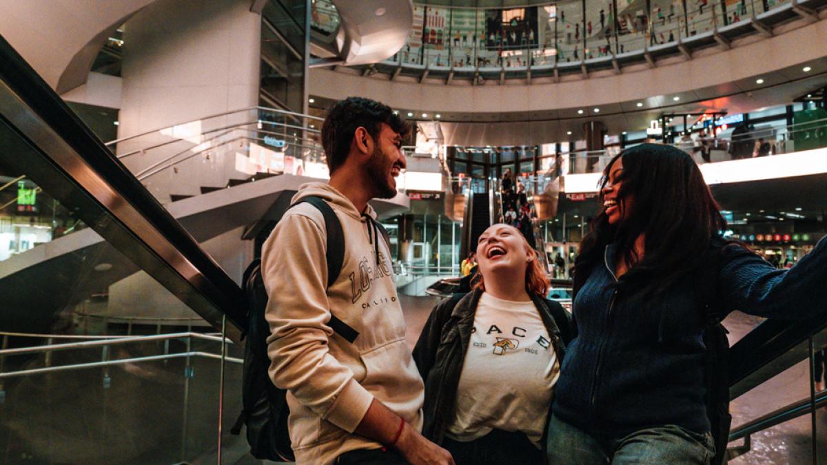 Pace students on the escalator at Fulton Center.