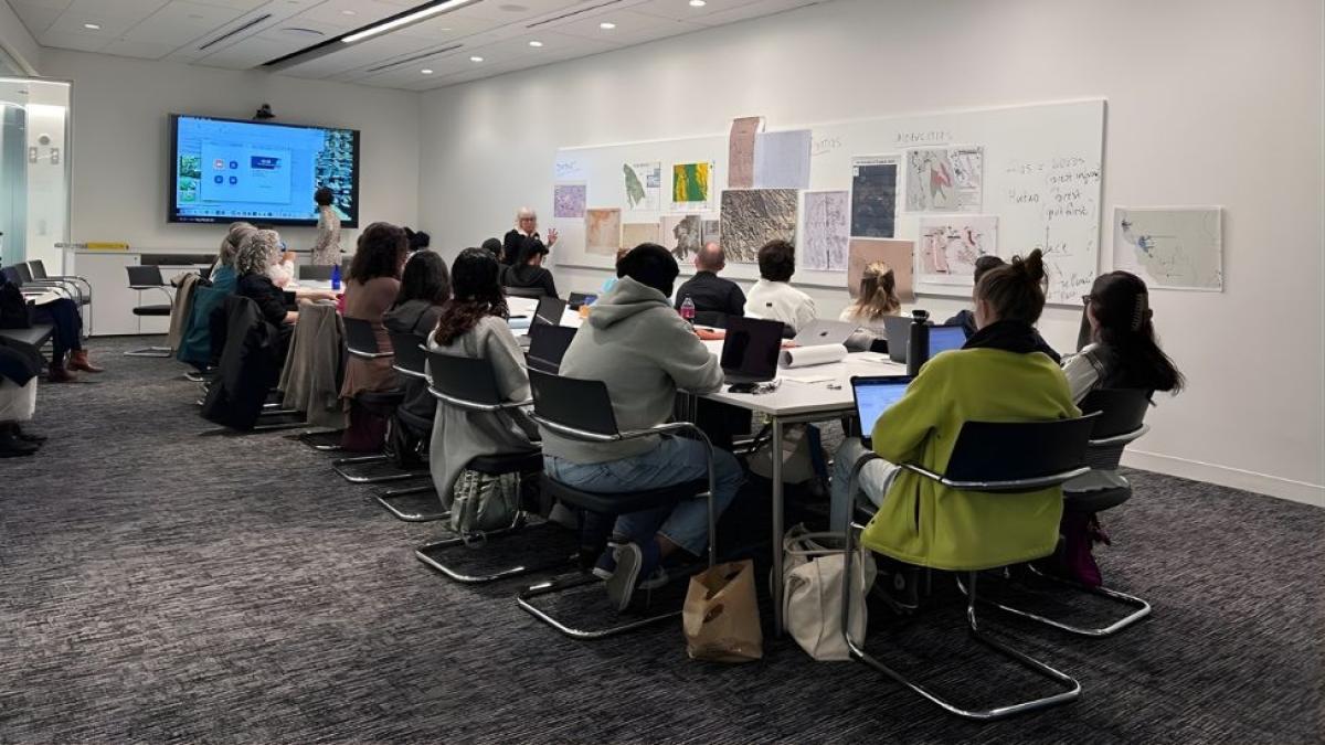 Dr. Nancy Peluso talking to students seated around a table during the countermapping workshop funded by the Mellon Grant, “Islands, Archipelagoes, and Cultural Ecologies.”