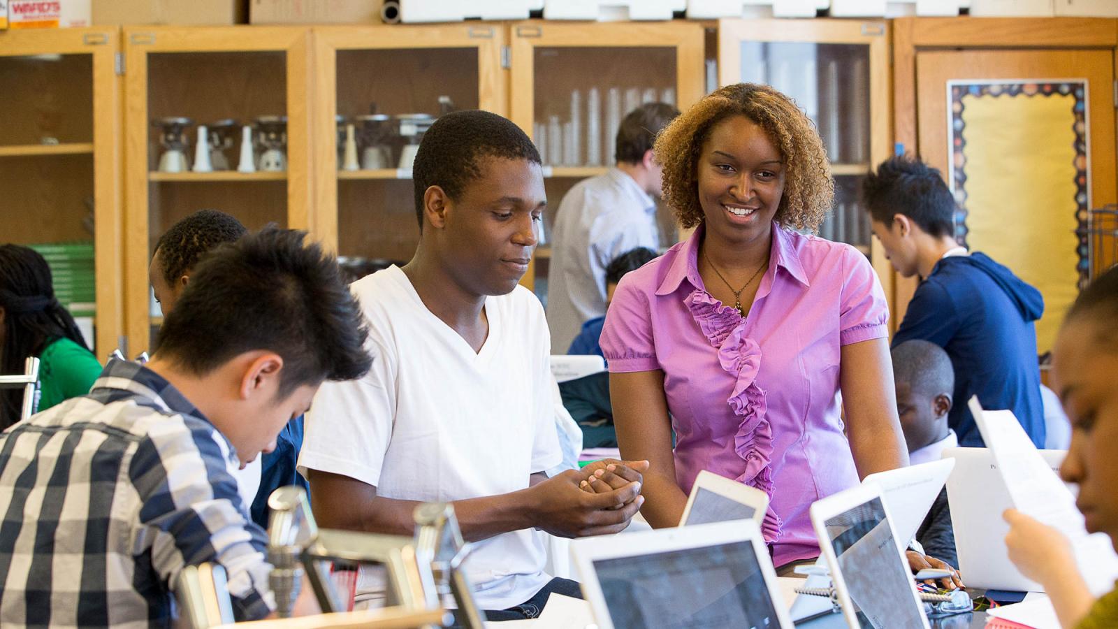 School of education student working in a classroom setting with students.