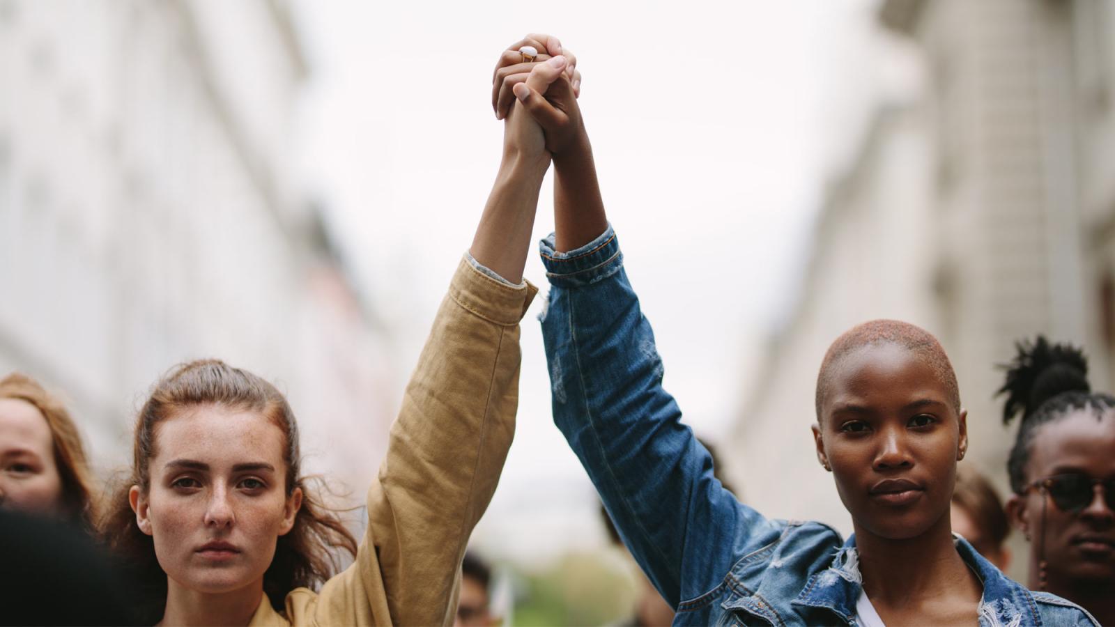 people with hands clasped in solidarity