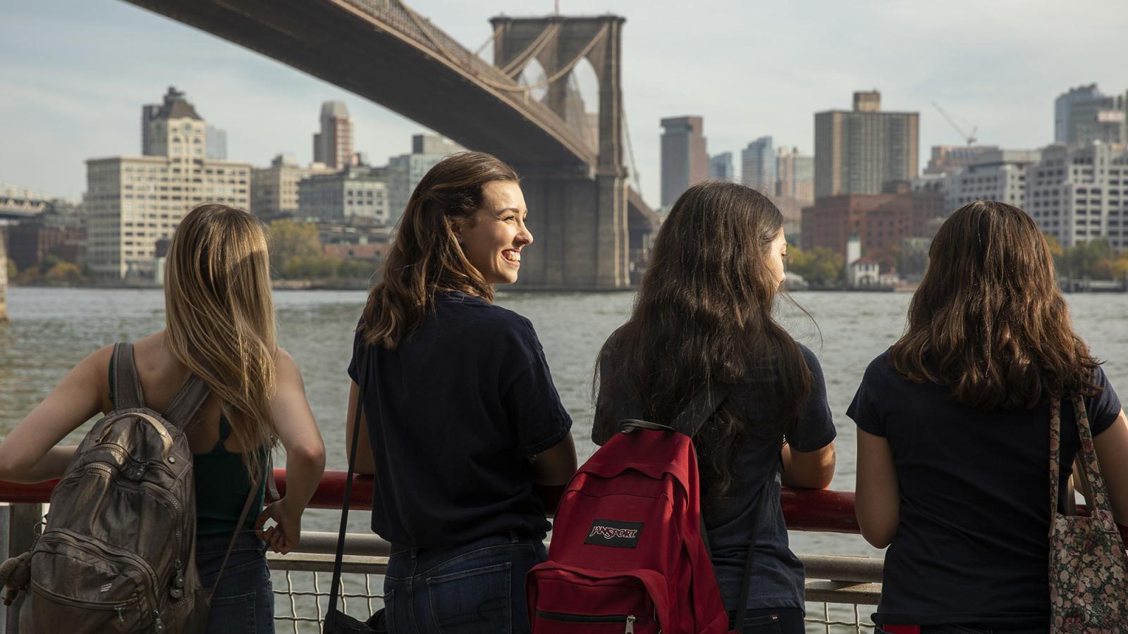 Pace students standing underneath the Brooklyn Bridge
