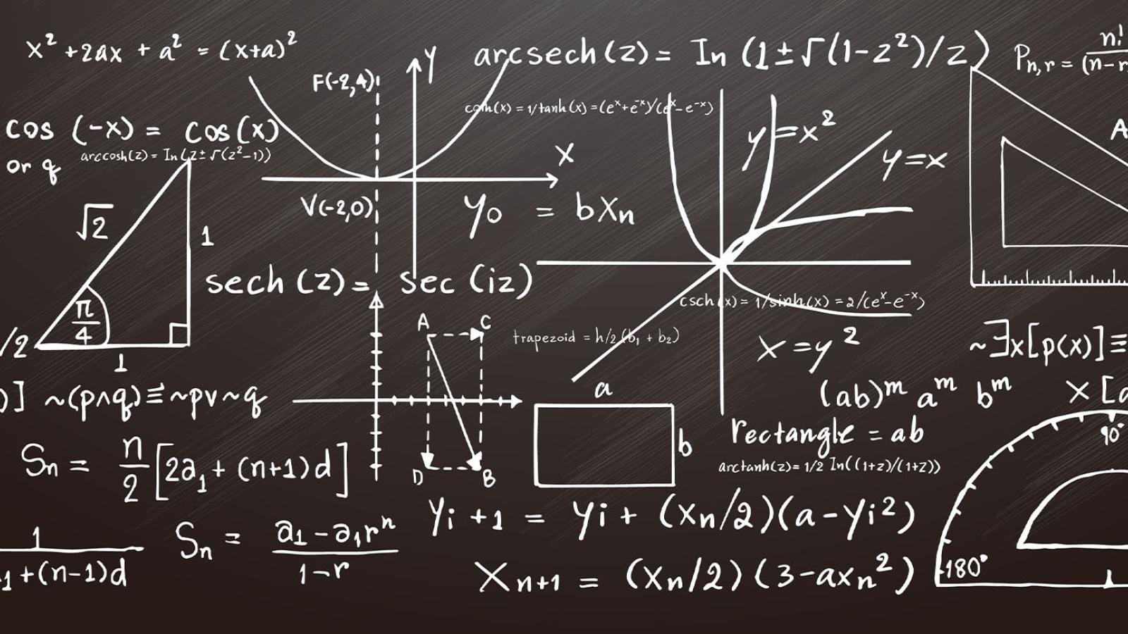 Mathematical equations on a black chalkboard