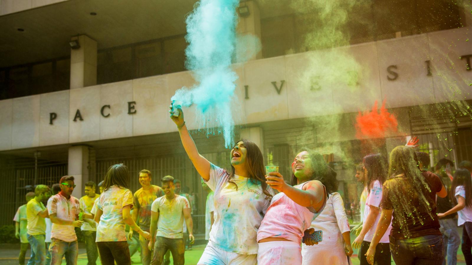 group of people throwing colored powder