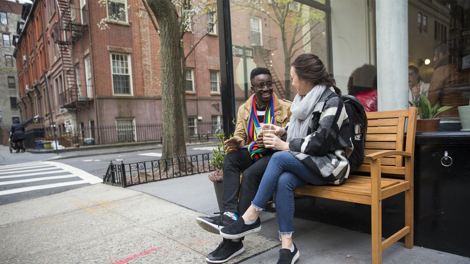 people sitting on a bench in nyc