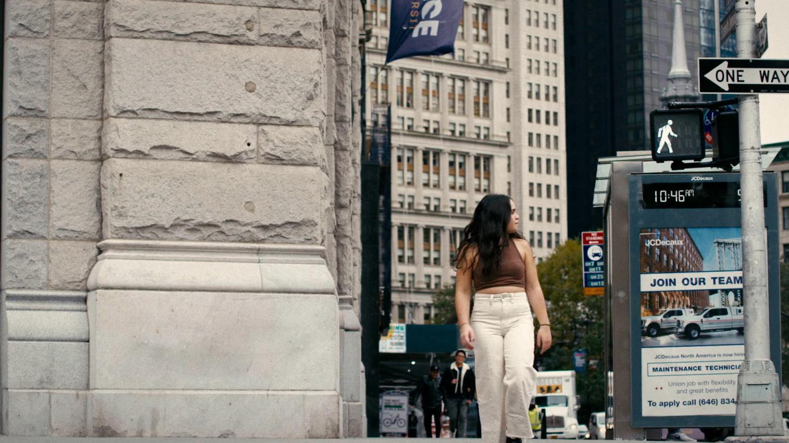 young woman crossing the street in new york city