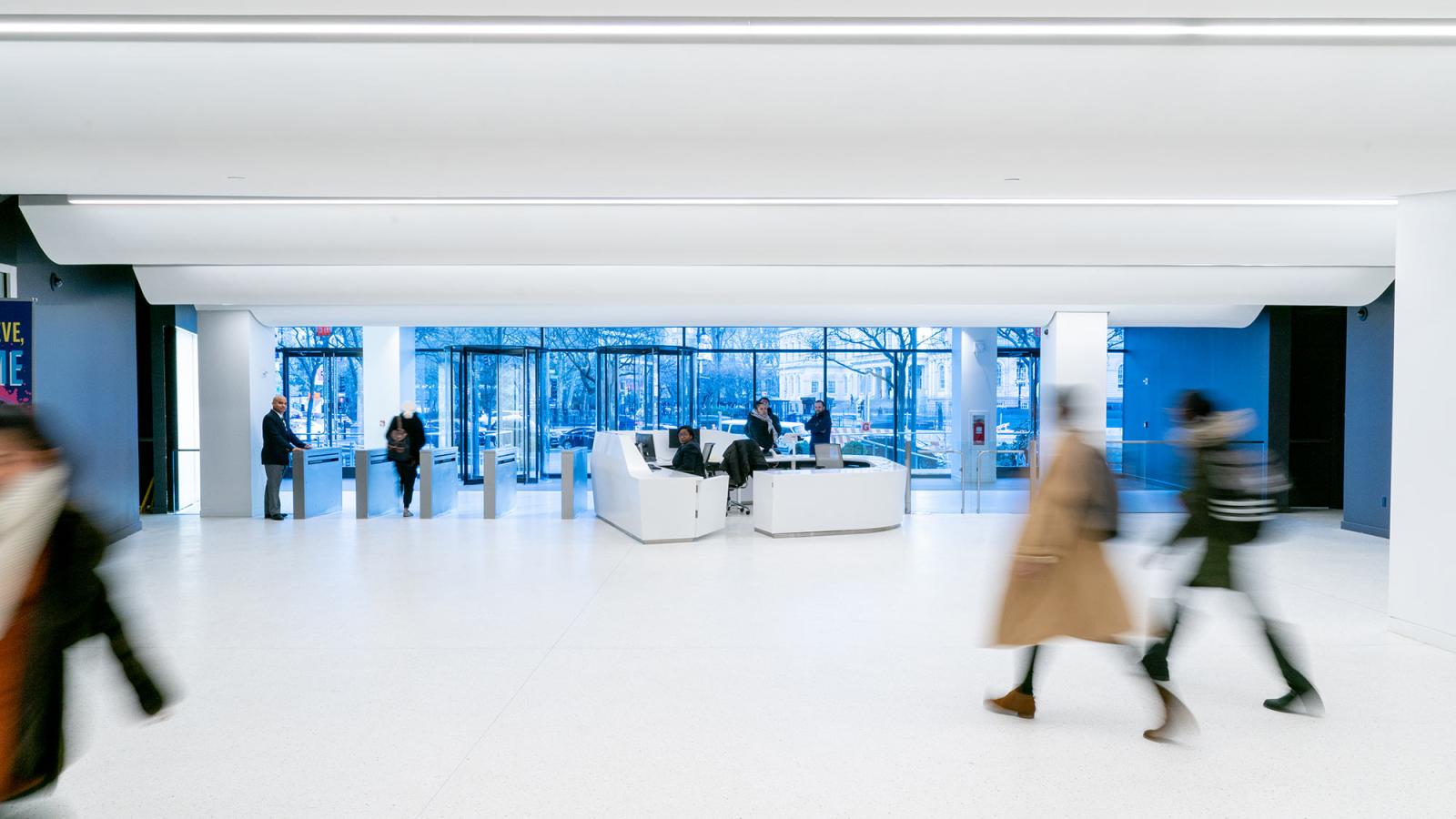 Students walking inside of 1 Pace Plaza in NYC.