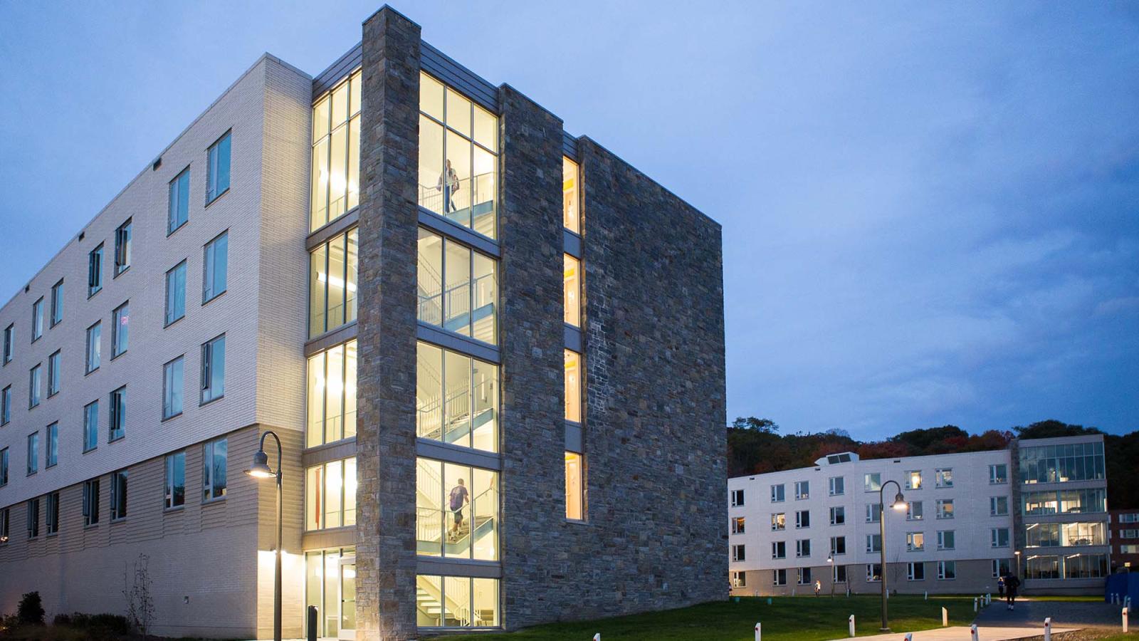 the exterior view of Alumni Hall at dusk