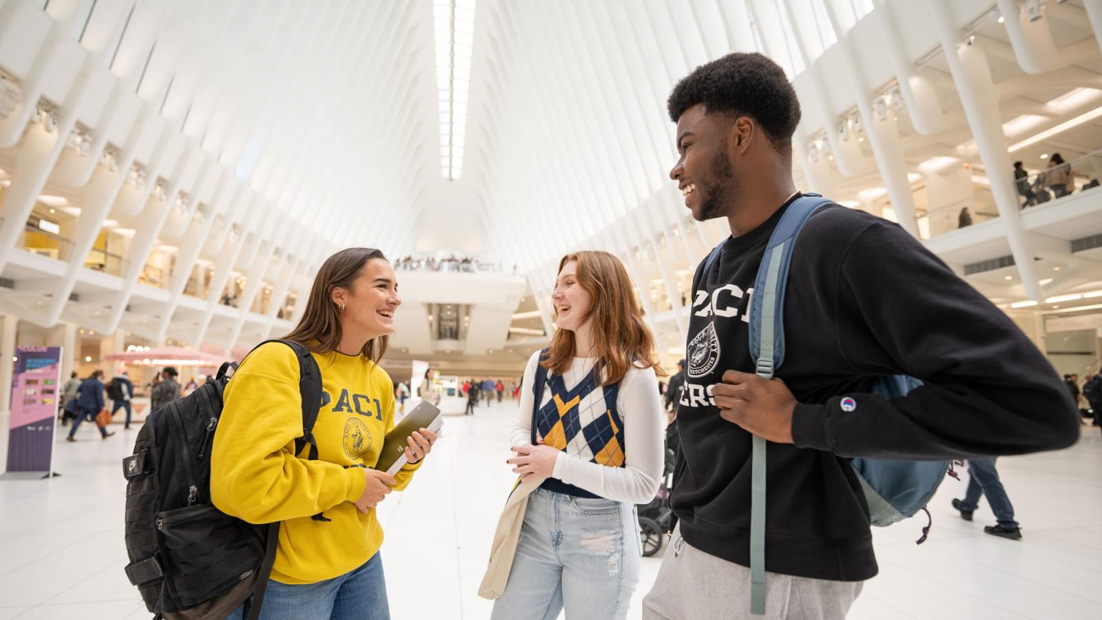 three people standing inside the oculus