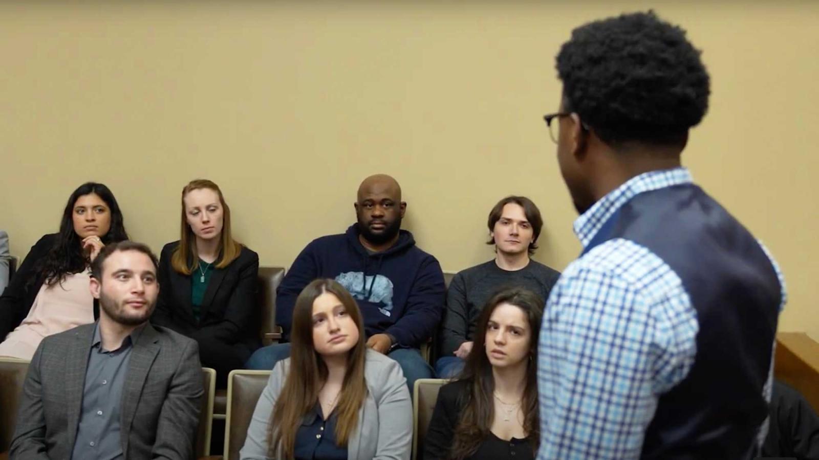 A professor speaking to a group of students on the Elisabeth Haub School of Law campus