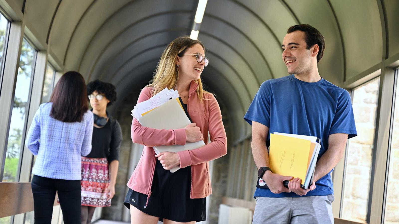 two students conversing in a hallway