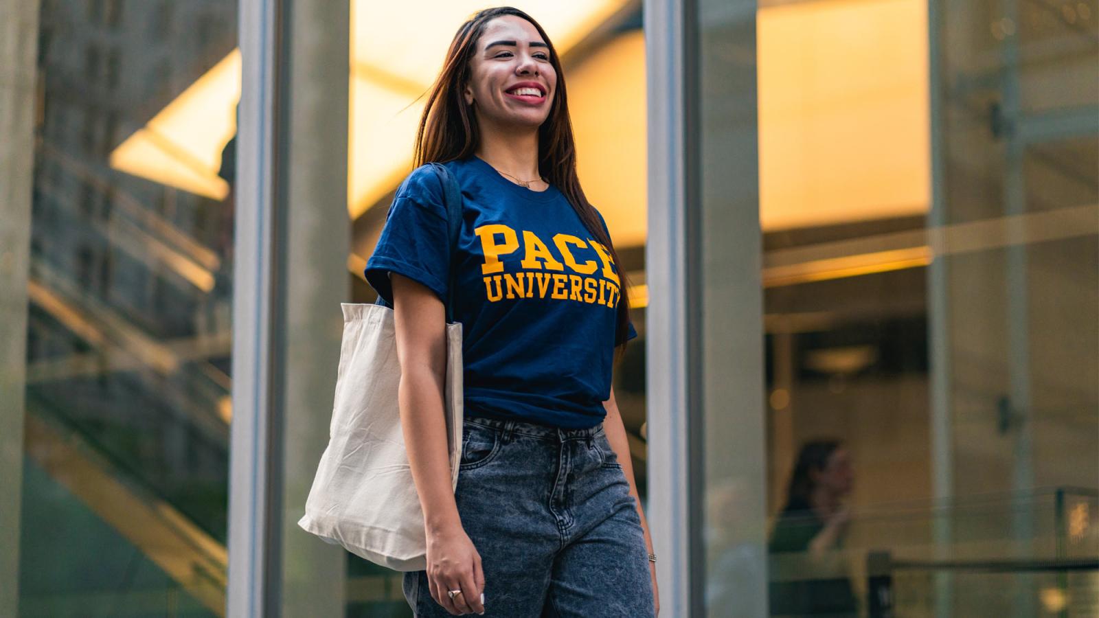 woman in a pace university tee shirt walking in NYC