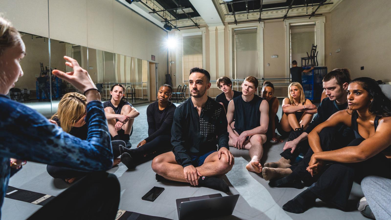 commercial dance students in a dance studio listening their instructor