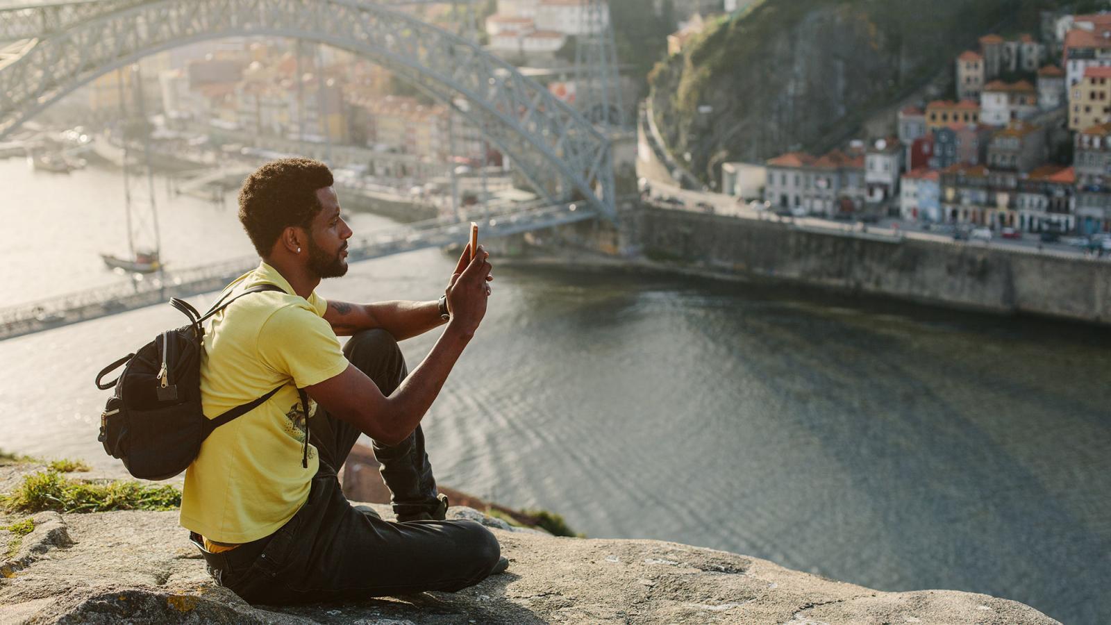 Student taking a picture with his phone.