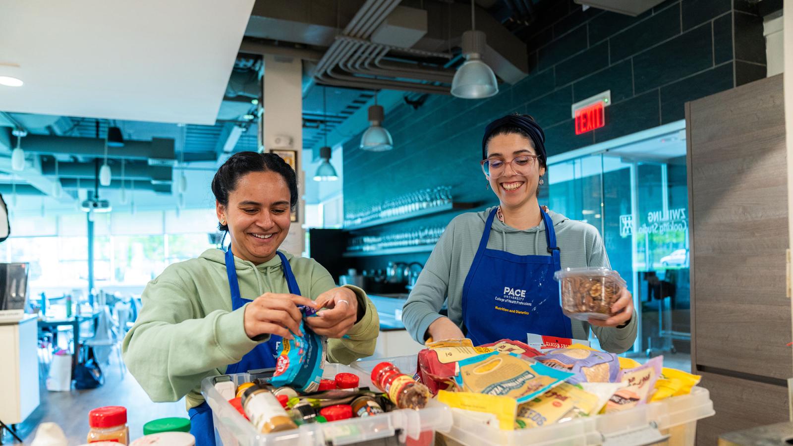 Two nutrition students working in the teaching kitchen.