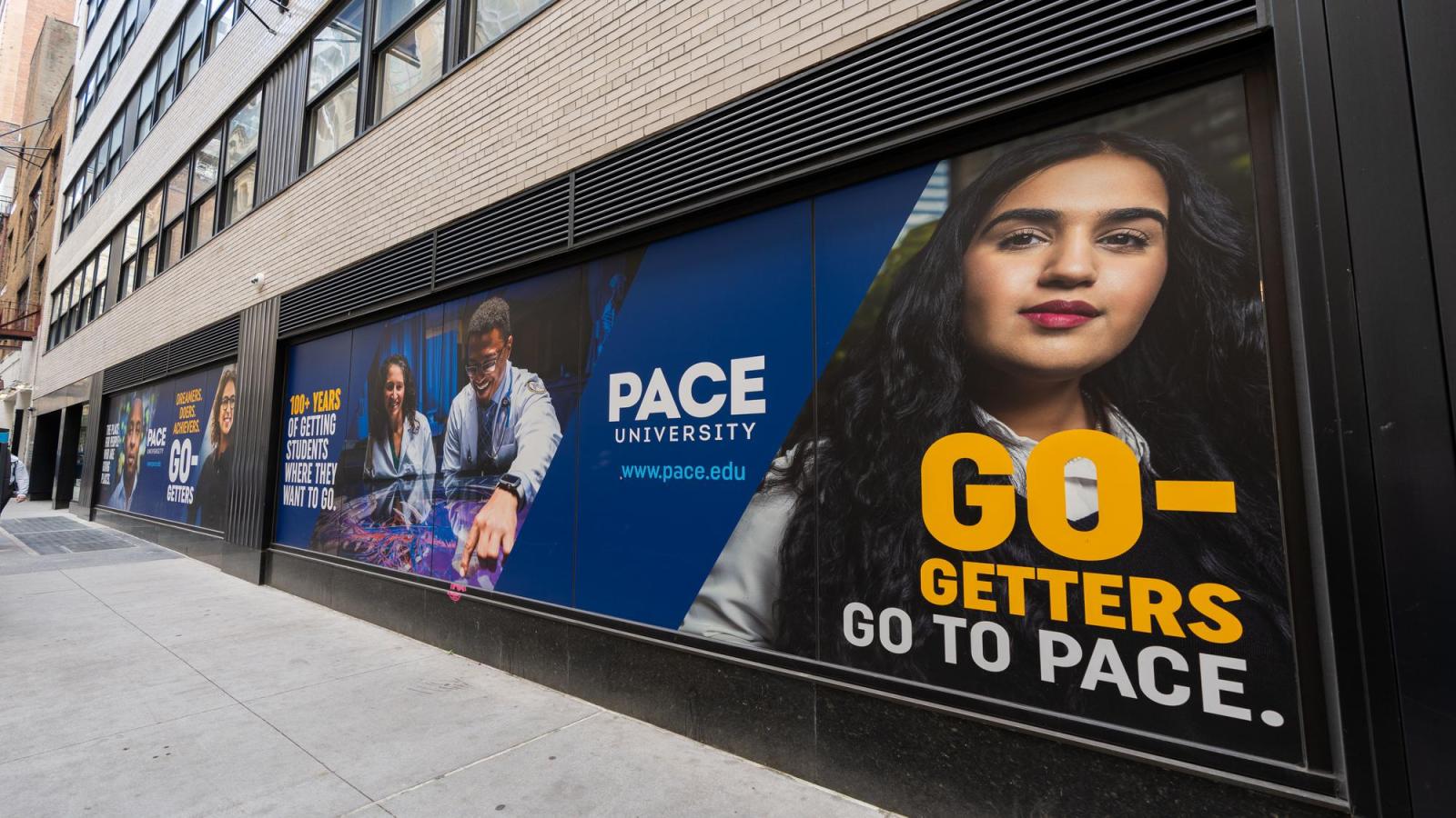 Pace University advertisements on the side of a building in New York City