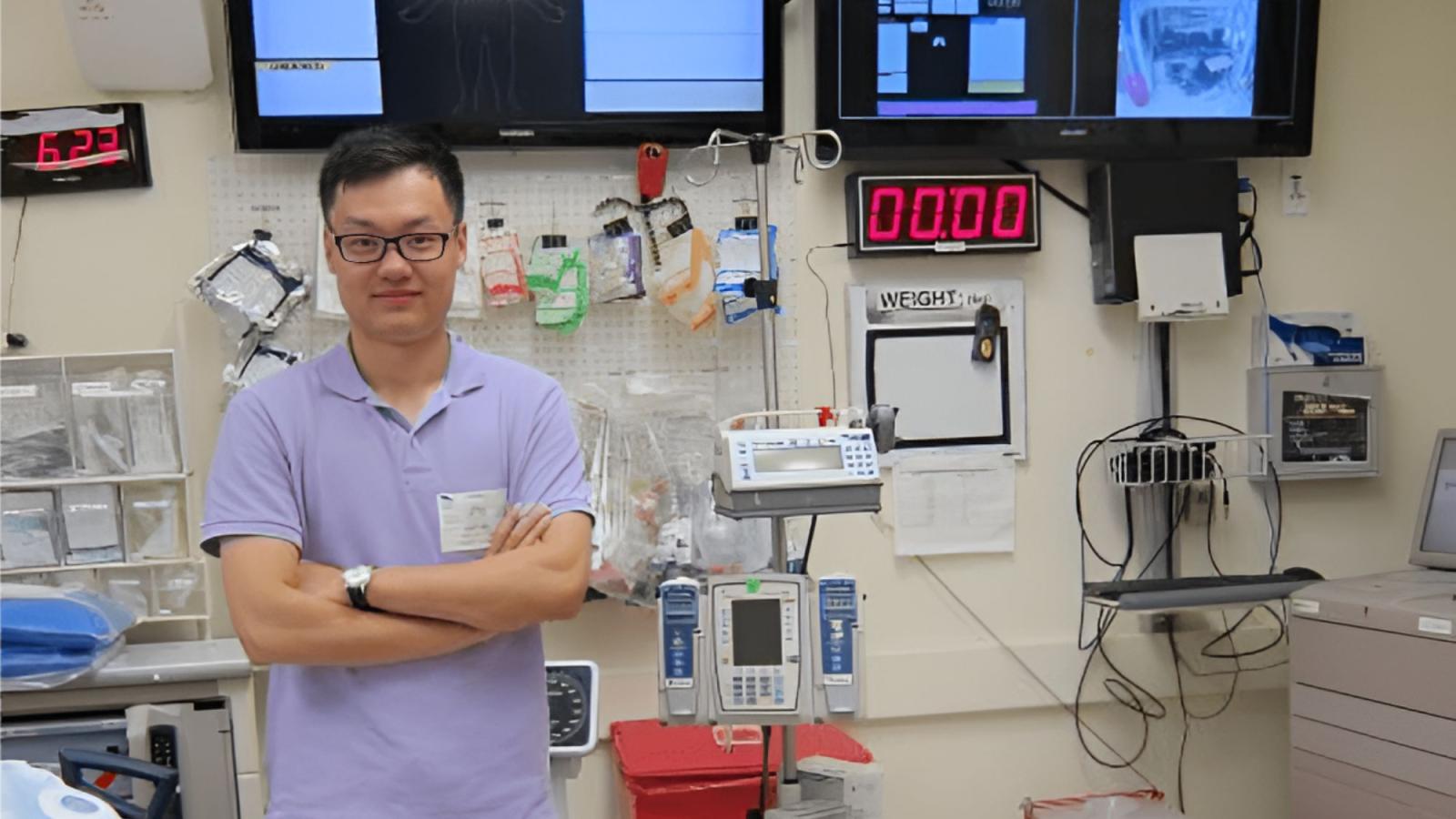 Seidenberg professor Dr. Zhan Zhang posing for a photo in front of medical equipment.