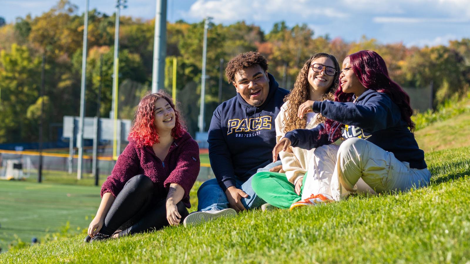 Group of students sitting on the lawn at the Pace University Pleasantville Campus