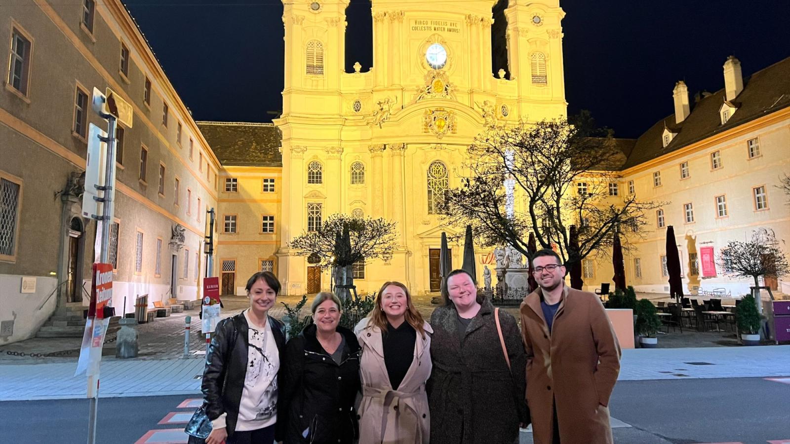 Elisabeth Haub School of Law at Pace University faculty and students standing in Vienna, Austria at night