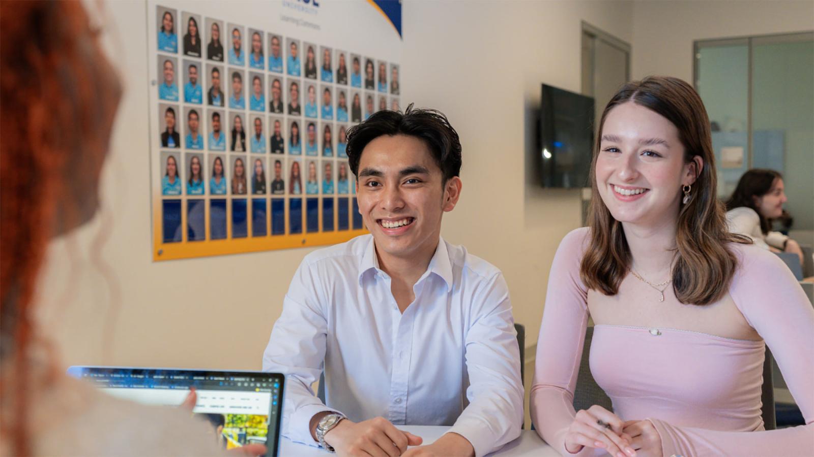 Two Pace University students working in the Learning Commons