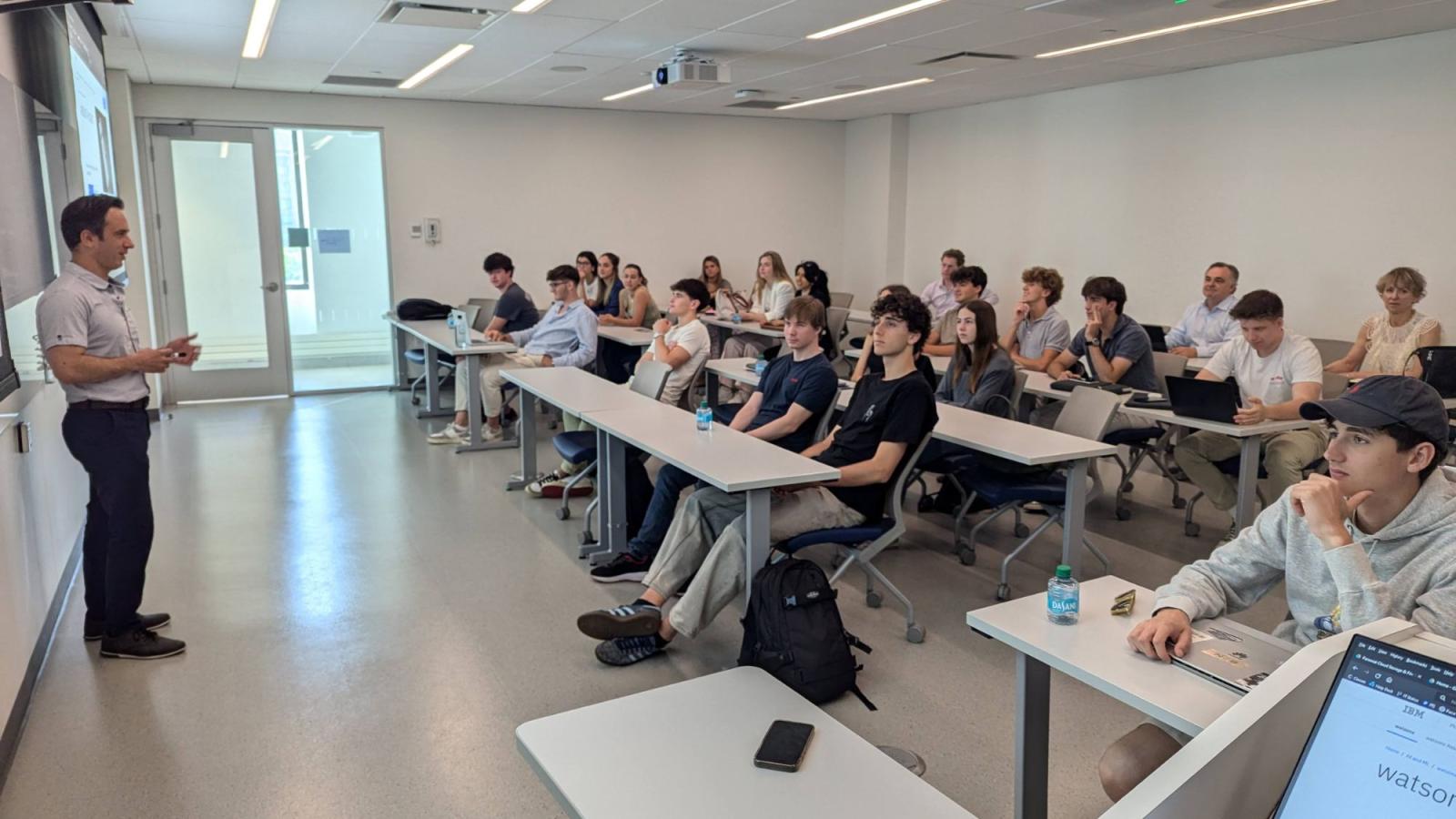 Seidenberg Professor Dr. Yegin Genc teaching in front of a full classroom of students from LaSalle Barcelona.