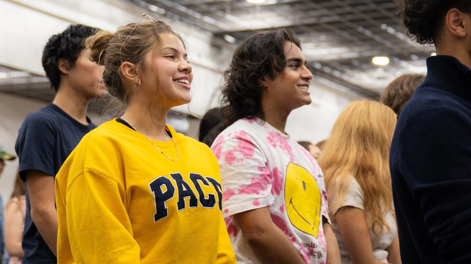 Pace University students smiling at the annual Convocation ceremony.