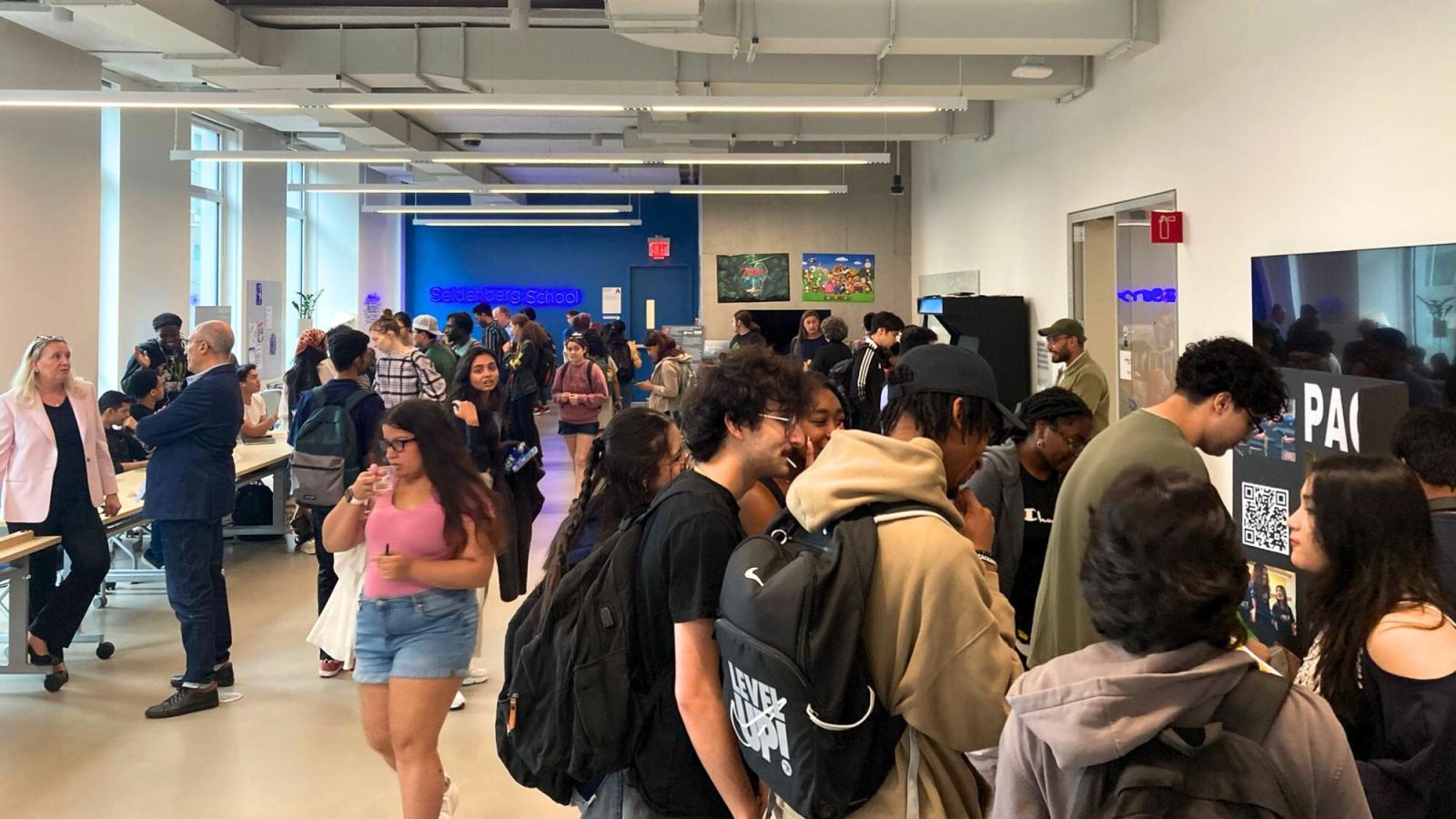 Pace University Seidenberg students and faculty talking and mingling in the NYC Design Factory space for the NYC Community Day.