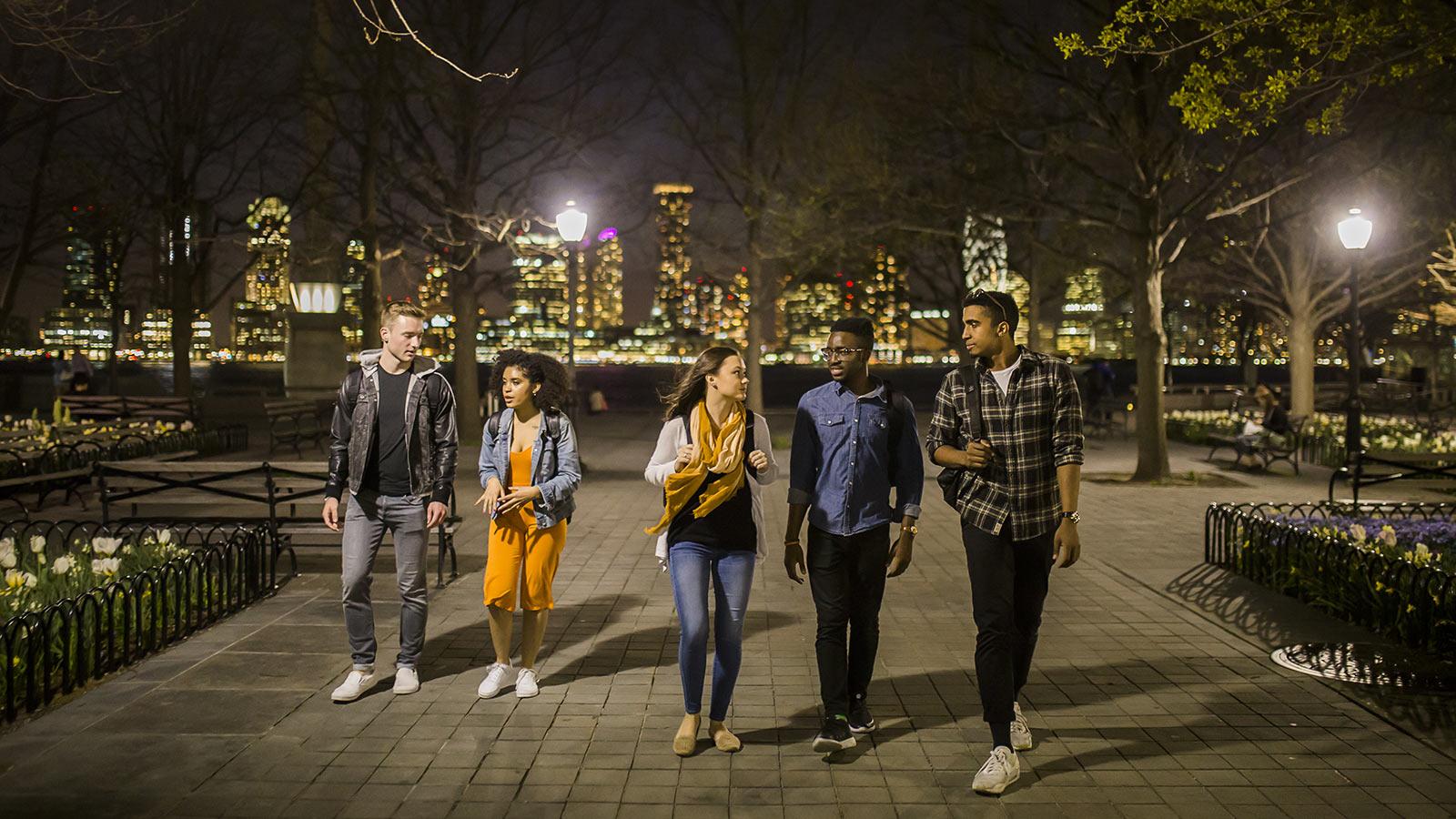 Pace University students walking through Manhattan at night.