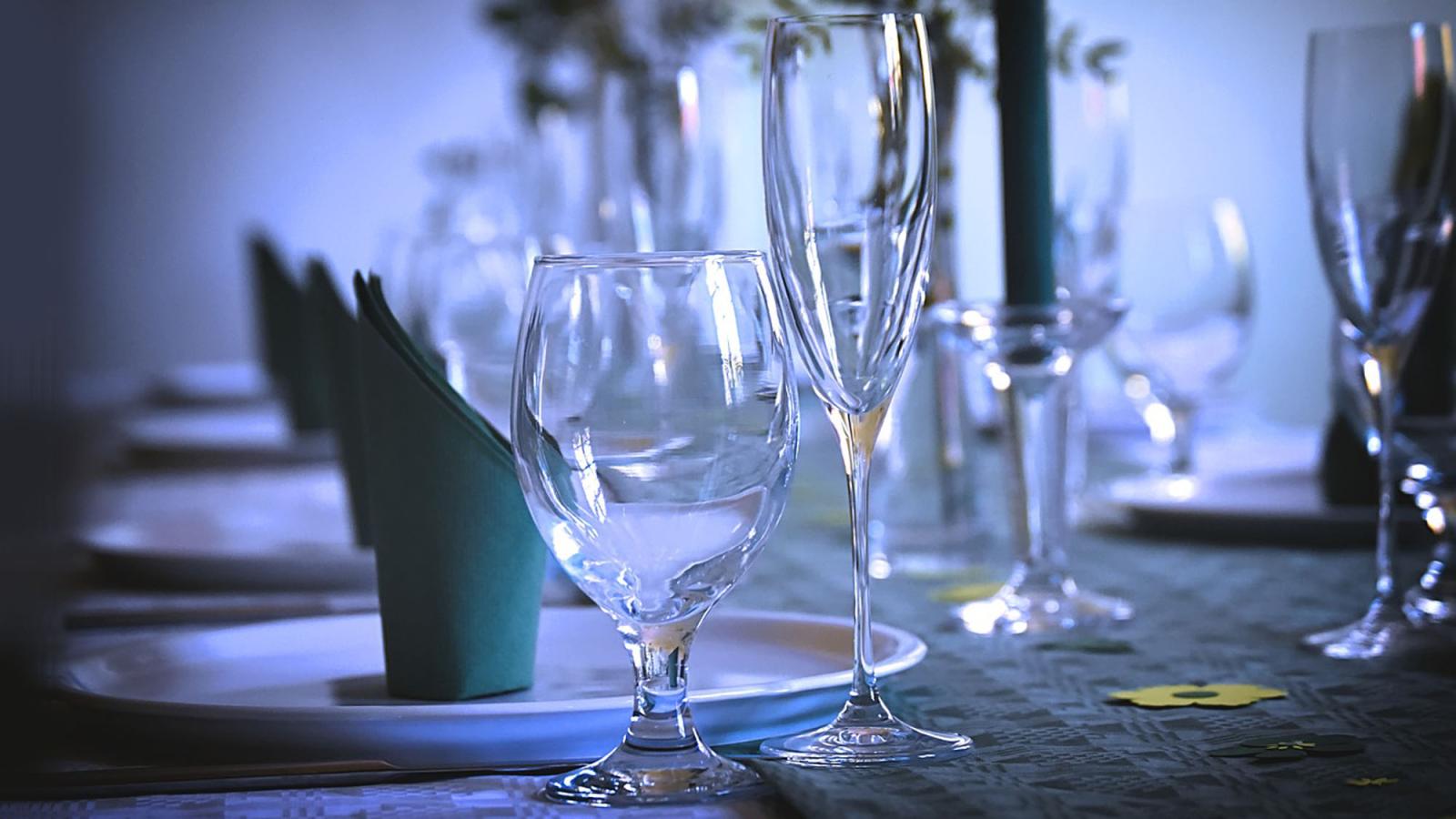 water glass, wine glass, napkin, and plate on formal table setting