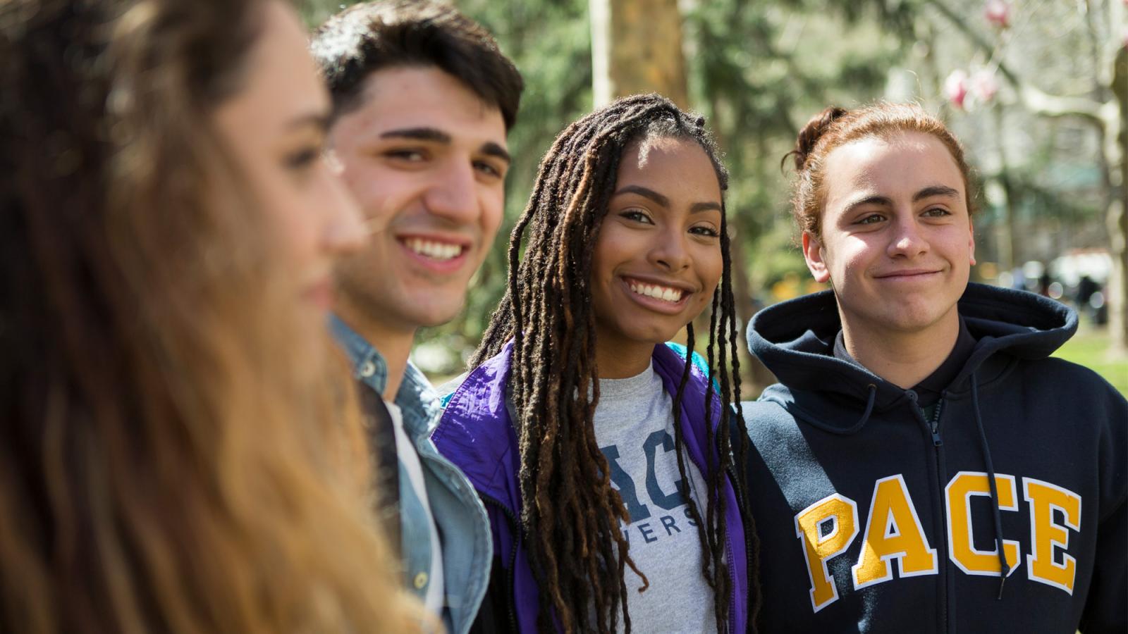 Pace students smiling at the camera.