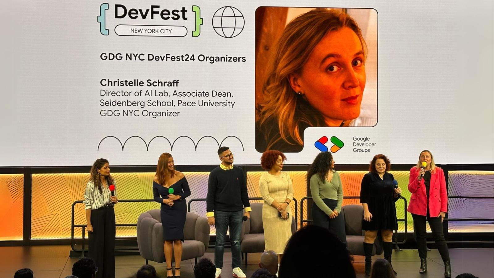 Pace University Seidenberg professor Dr. Christelle Scharff standing on the stage with fellow organizers of the DGD DevFest NYC.