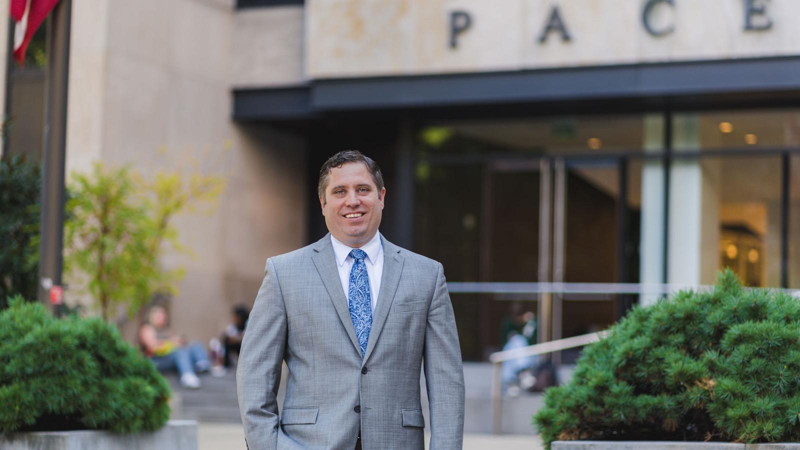 Pace's Director of Energy and Resiliency Ryan McEnany posing in front of One Pace Plaza. 