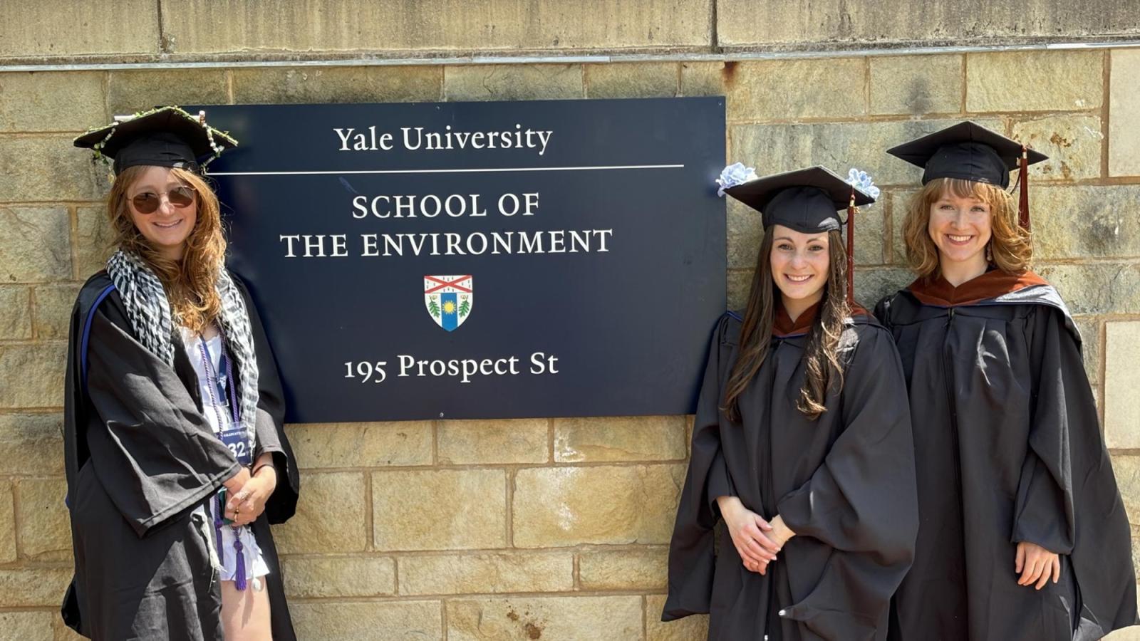 Haub Law students in from of a sign at the Yale School of the Environment