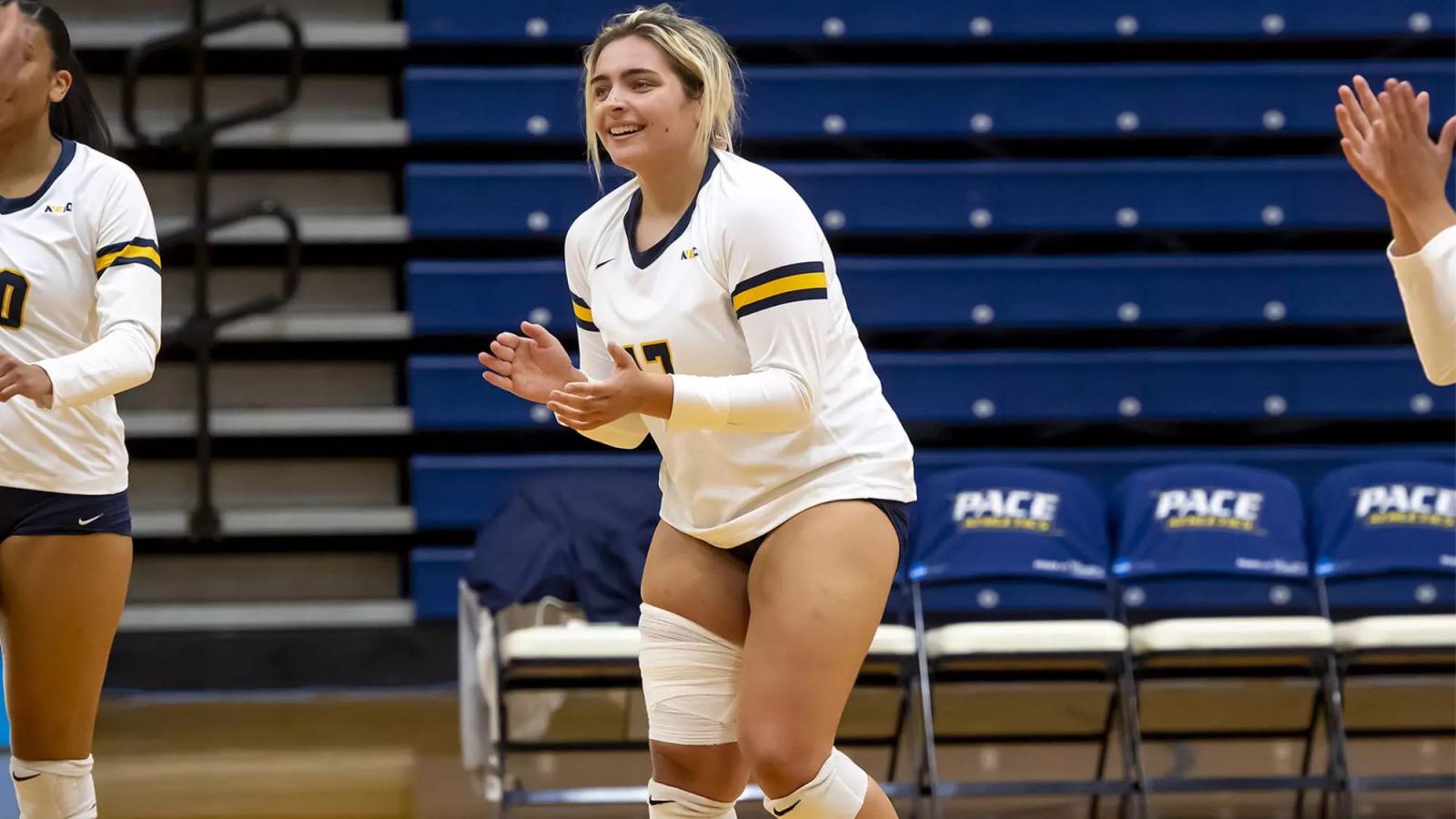 Stephanie Sicilian, student at Pace University's Seidenberg School of CSIS standing on the volleyball court during a game for Pace's women's volleyball team.