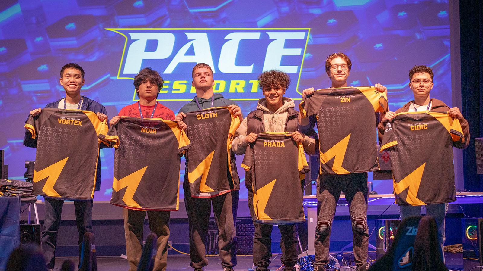a Pace Esports team holds their jerseys up at an awards ceremony