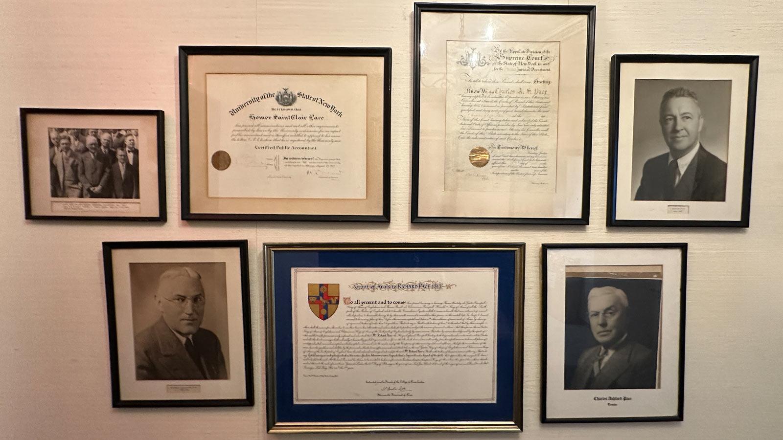 wall featureing framed images and certificates related to pace's history