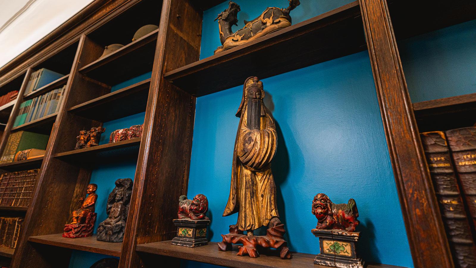 detailed view of antique sculptures on the shelves in the Pace Study. 